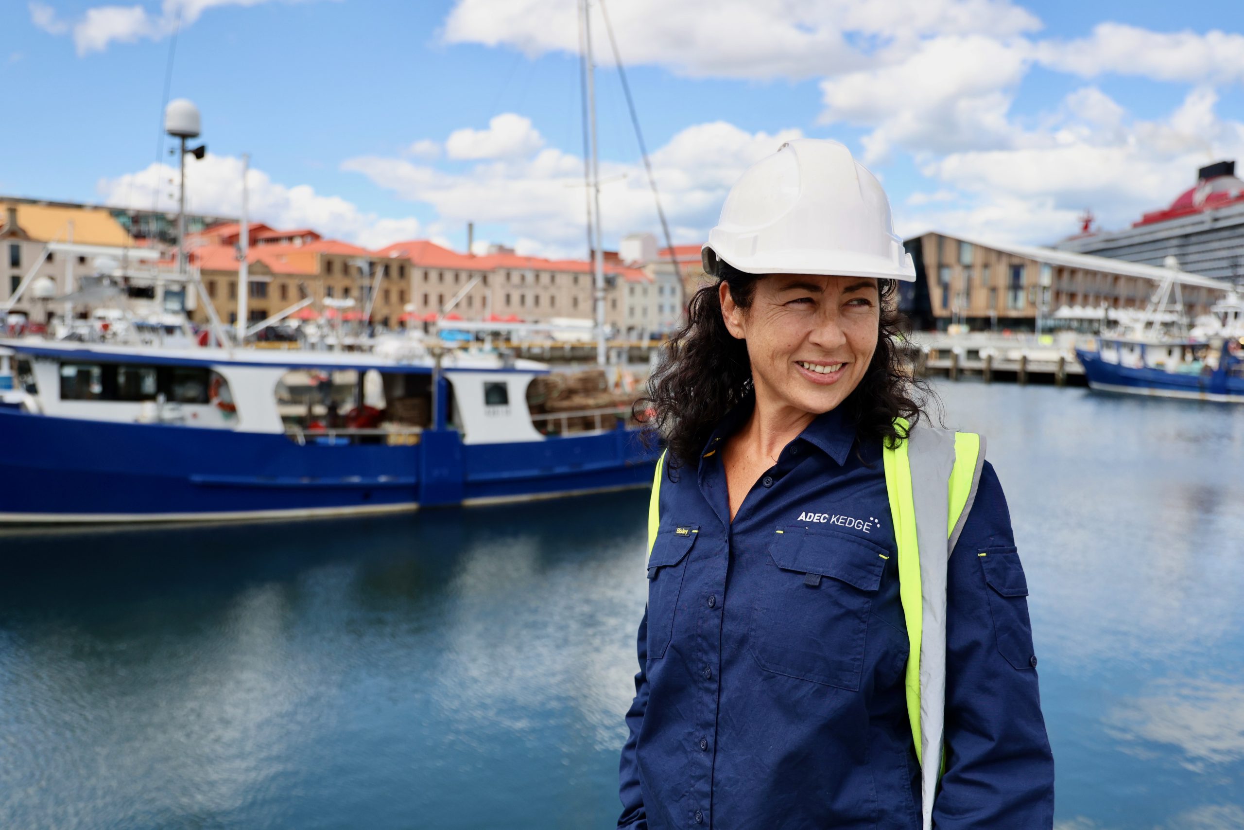 Marine Surveyor wearing hard hat and hi-vis vest at Hobart waterfront